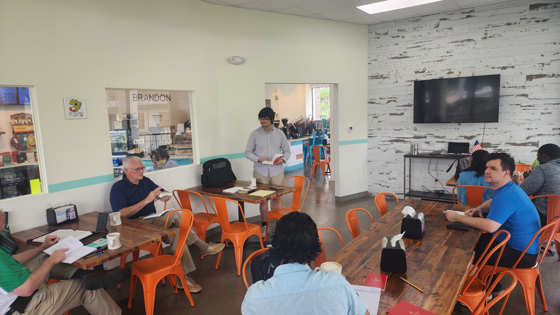 Elias leading a Bible study gathering at a coffee shop