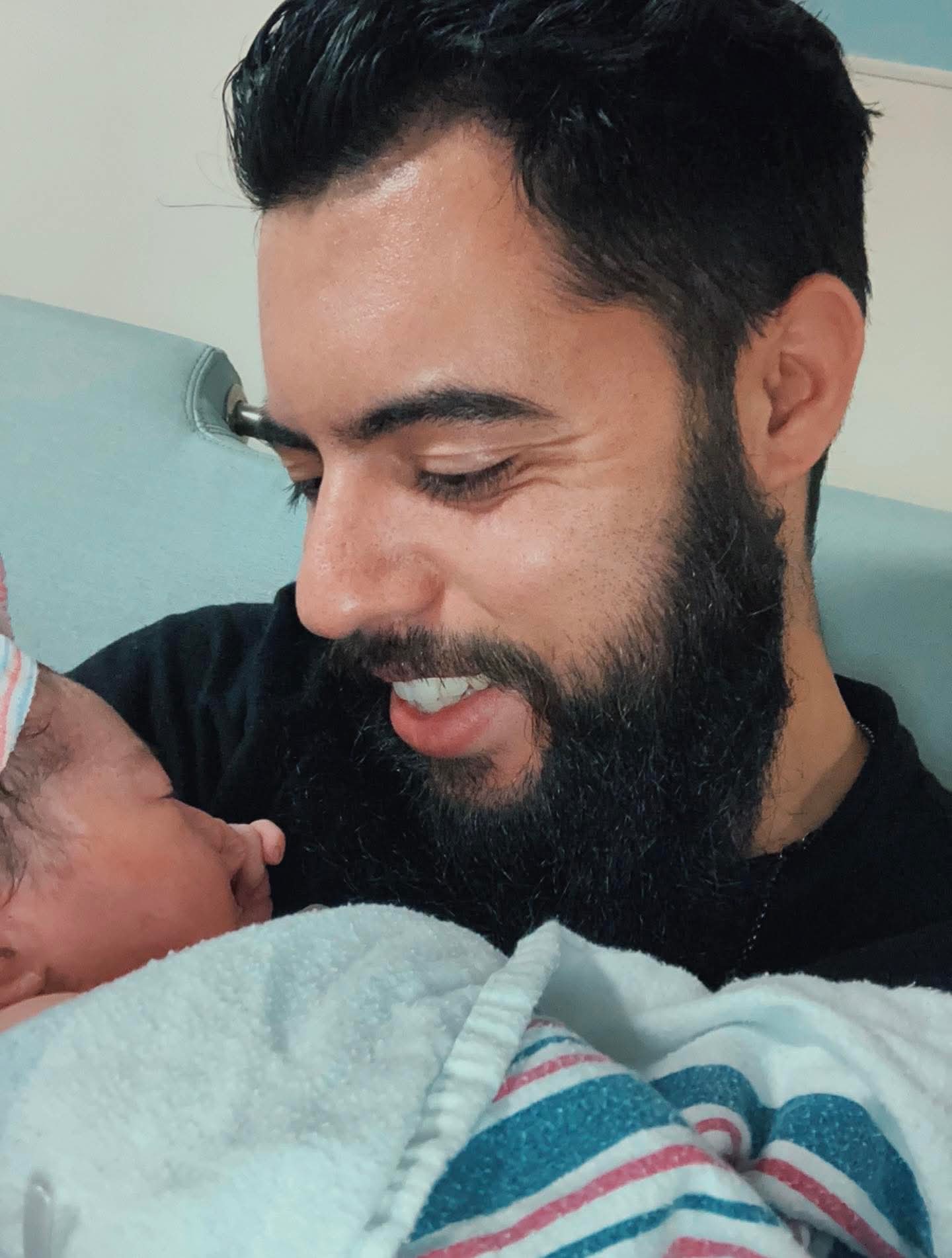 Elias holding his newborn daughter Lylla at the hospital
