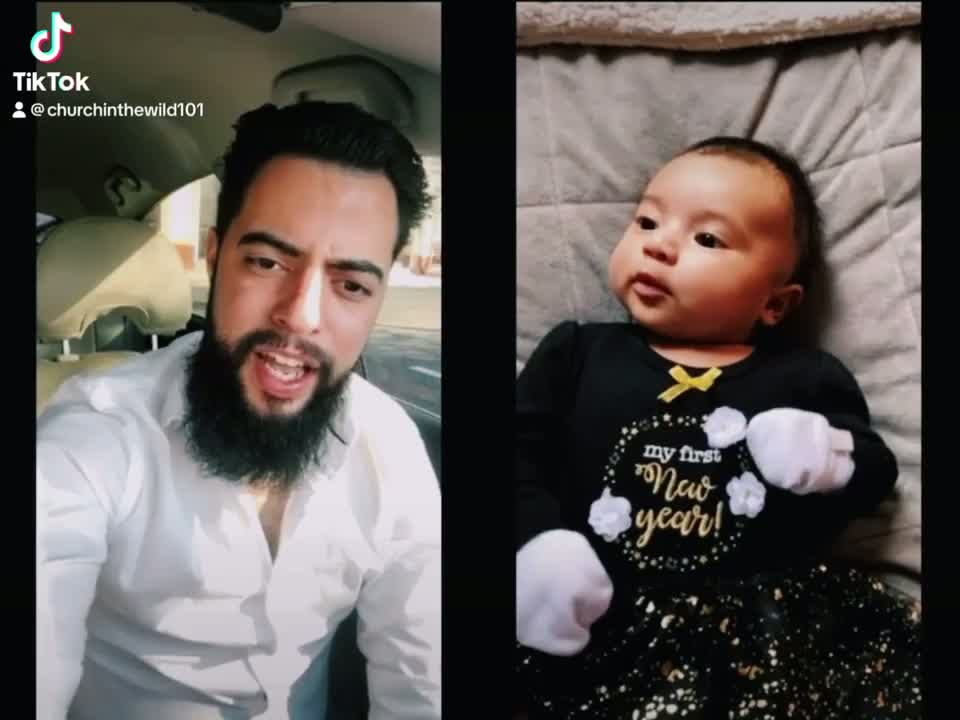 Elias on a FaceTime call from his car, his infant daughter on the other side of the screen